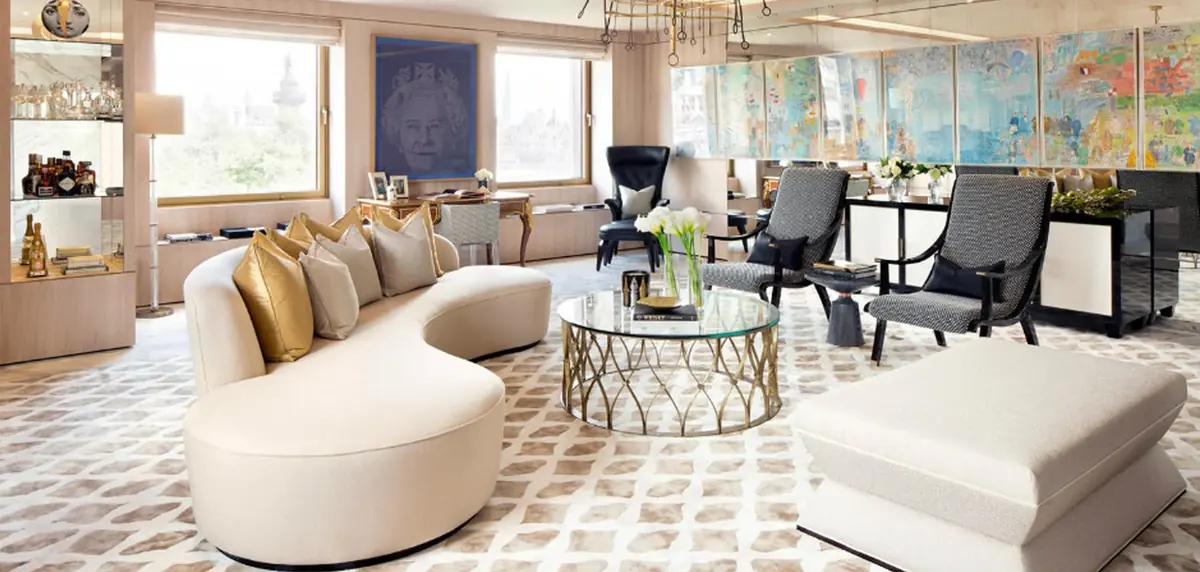 Curved cream sofa, glass coffee table and bespoke furniture in a St James's Park townhouse living room