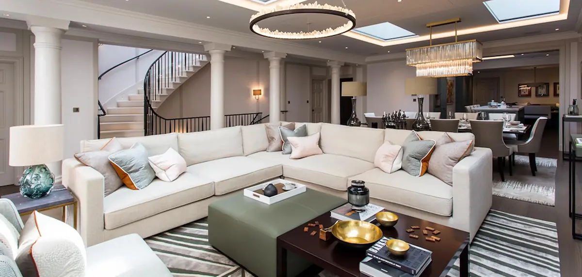 Belgrave Square living area with white corner sofa, spiral staircase and glazed roof lights