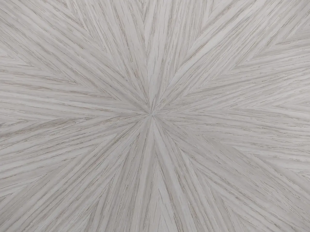 Radiating sunburst pattern in pale grey-washed wood veneer, veneer matching detail