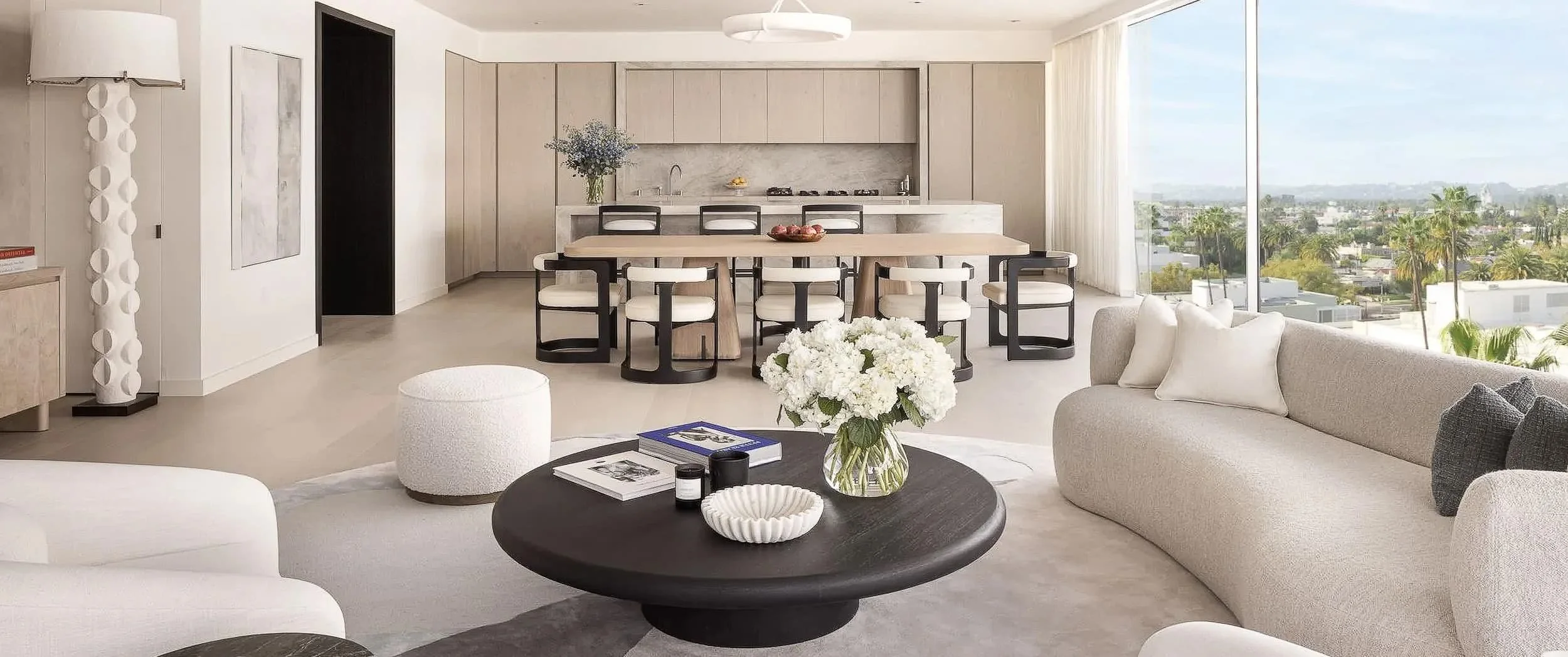 Open plan living room with cream bouclé pouf and a curved textured sofa, Mandarin Oriental Residences Beverly Hills