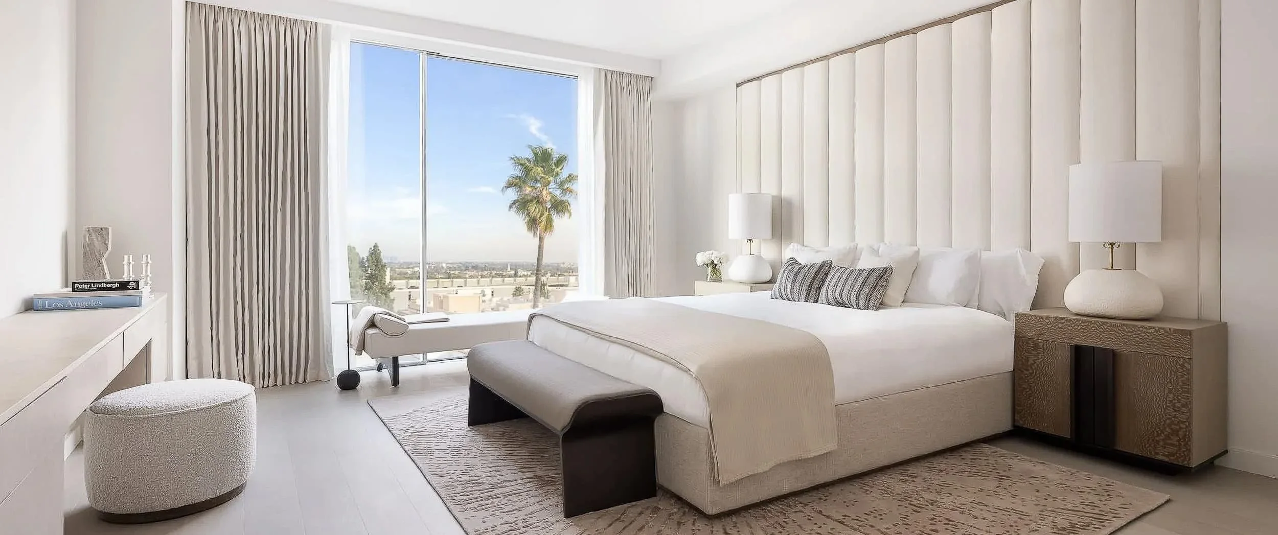Principal bedroom with panelled headboard wall, bench and curtained city view, Mandarin Oriental Residences