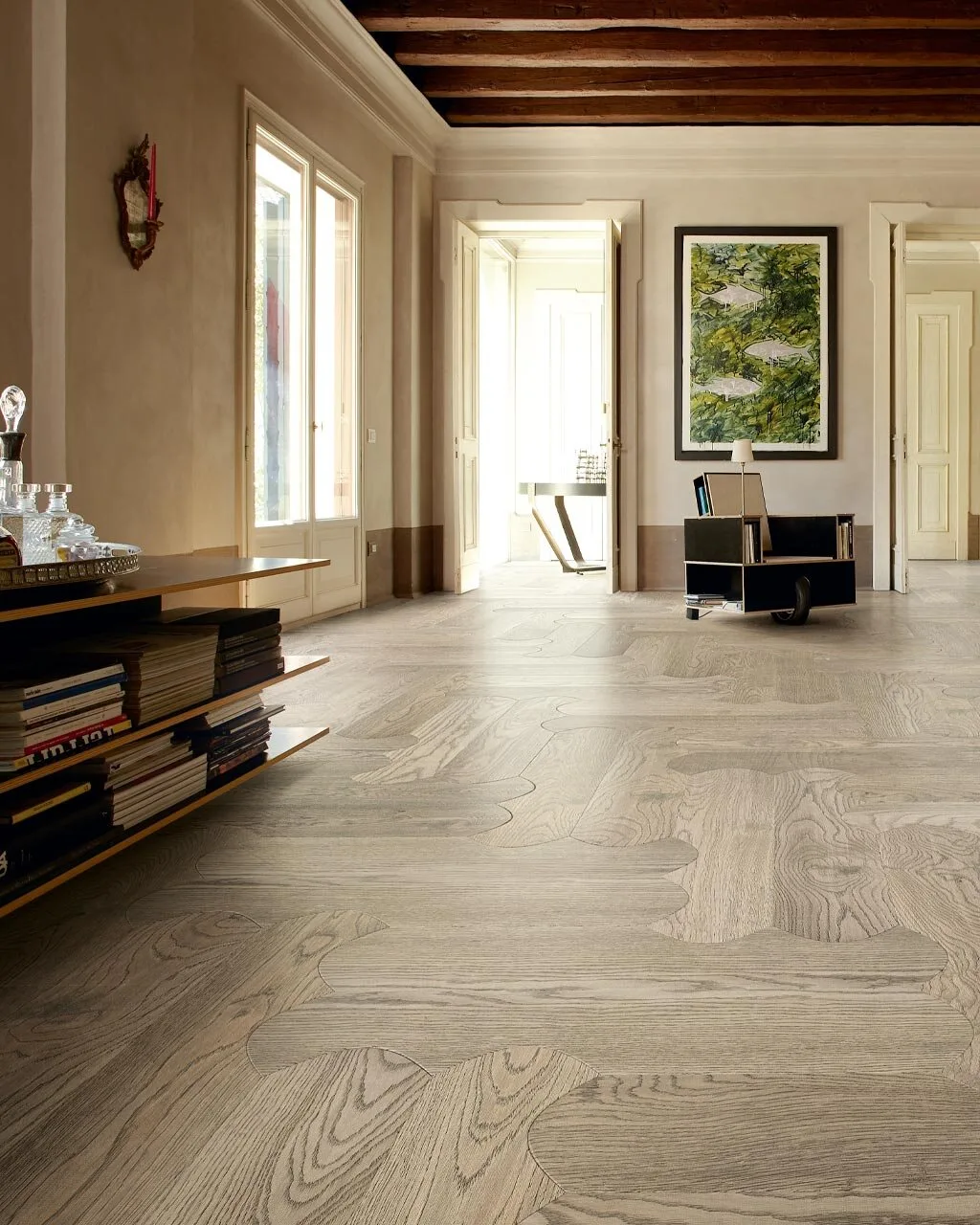 Biscuit Pienza oak floor in a high-ceilinged room with bookshelves, tall doors and a beamed ceiling
