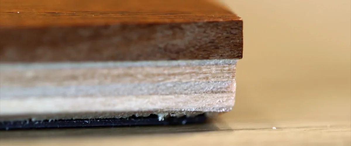 Cross-section of an engineered oak board: a layer of oak bonded to a layered core