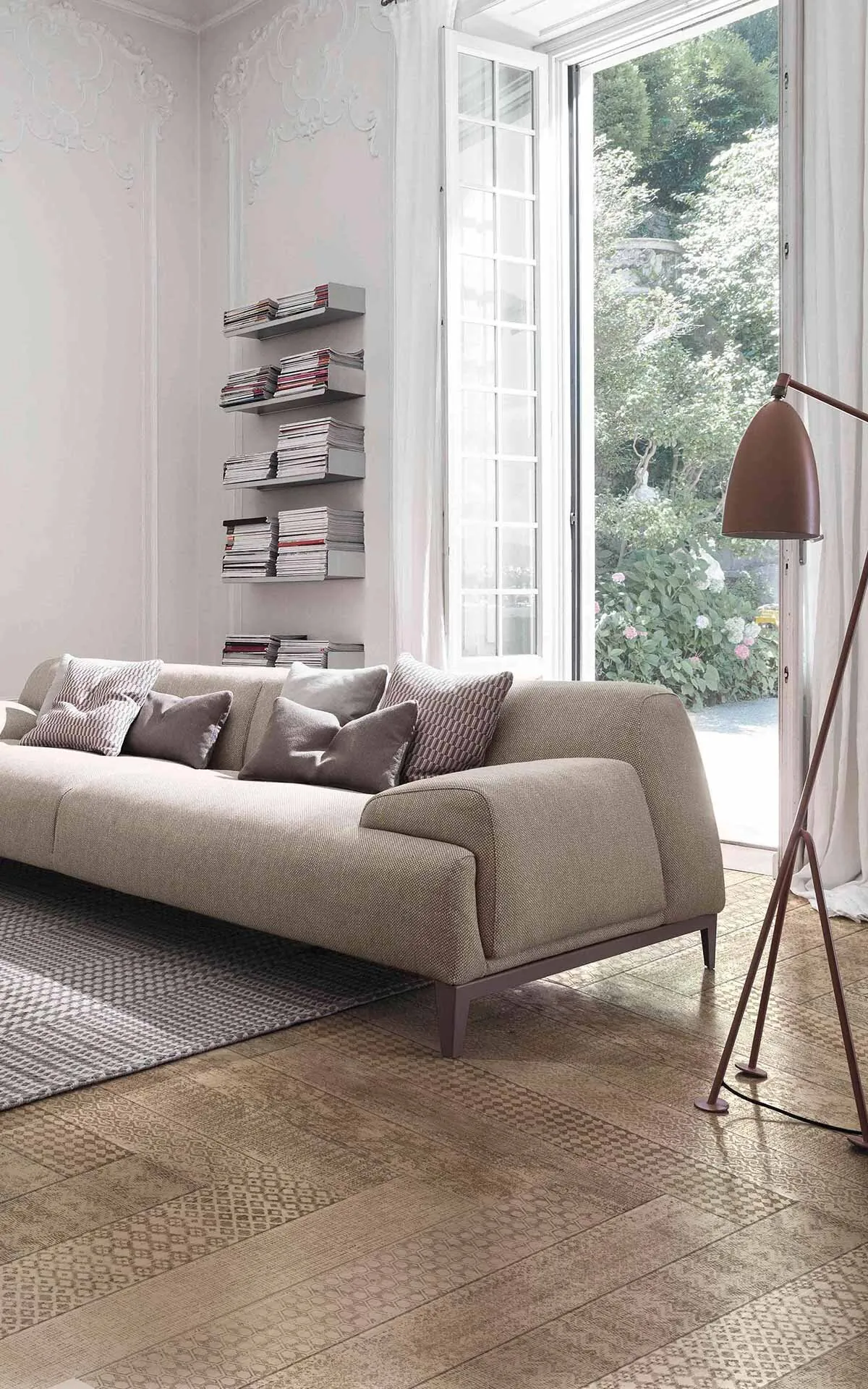 Undici engraved oak parquet in a living room with a grey sofa, a floor lamp and a tall French window