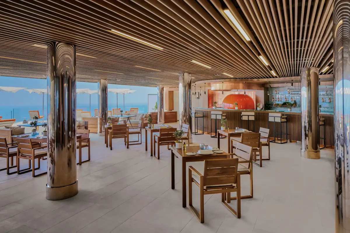 Covered terrace dining with slatted timber ceiling, steel columns and timber chairs, bespoke outdoor furniture