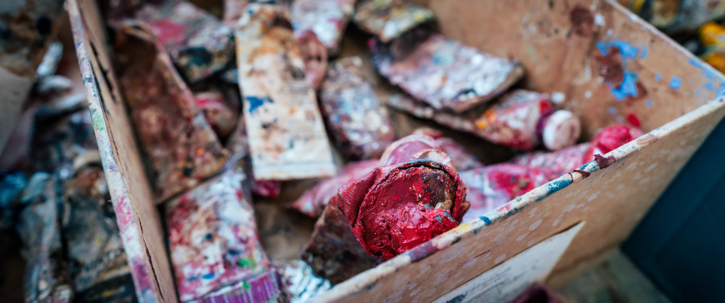 A box of the artist's used oil-paint tubes.