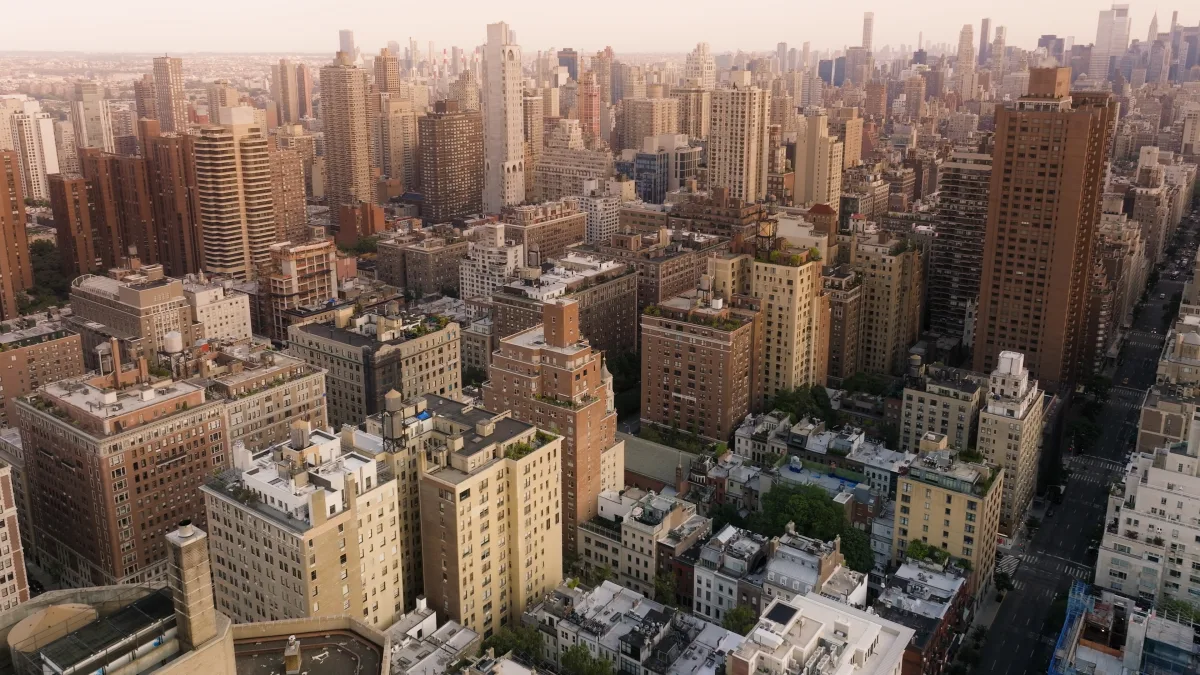 The Manhattan skyline on the Upper East Side at golden hour, the neighbourhood of the Madison Avenue members' club.