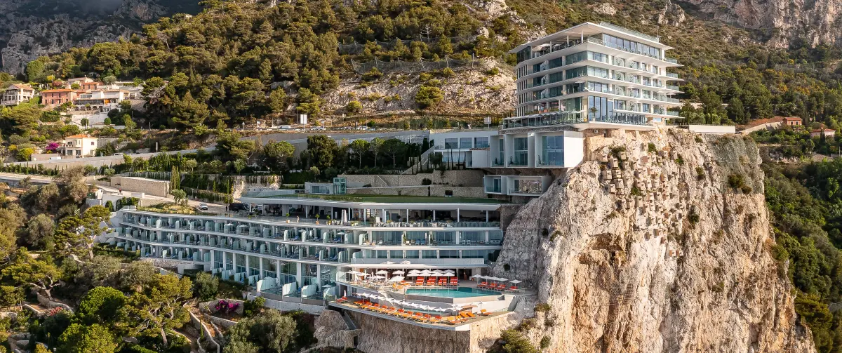 Maybourne Riviera hotel set on a rocky clifftop above the sea, aerial view of a luxury hospitality project