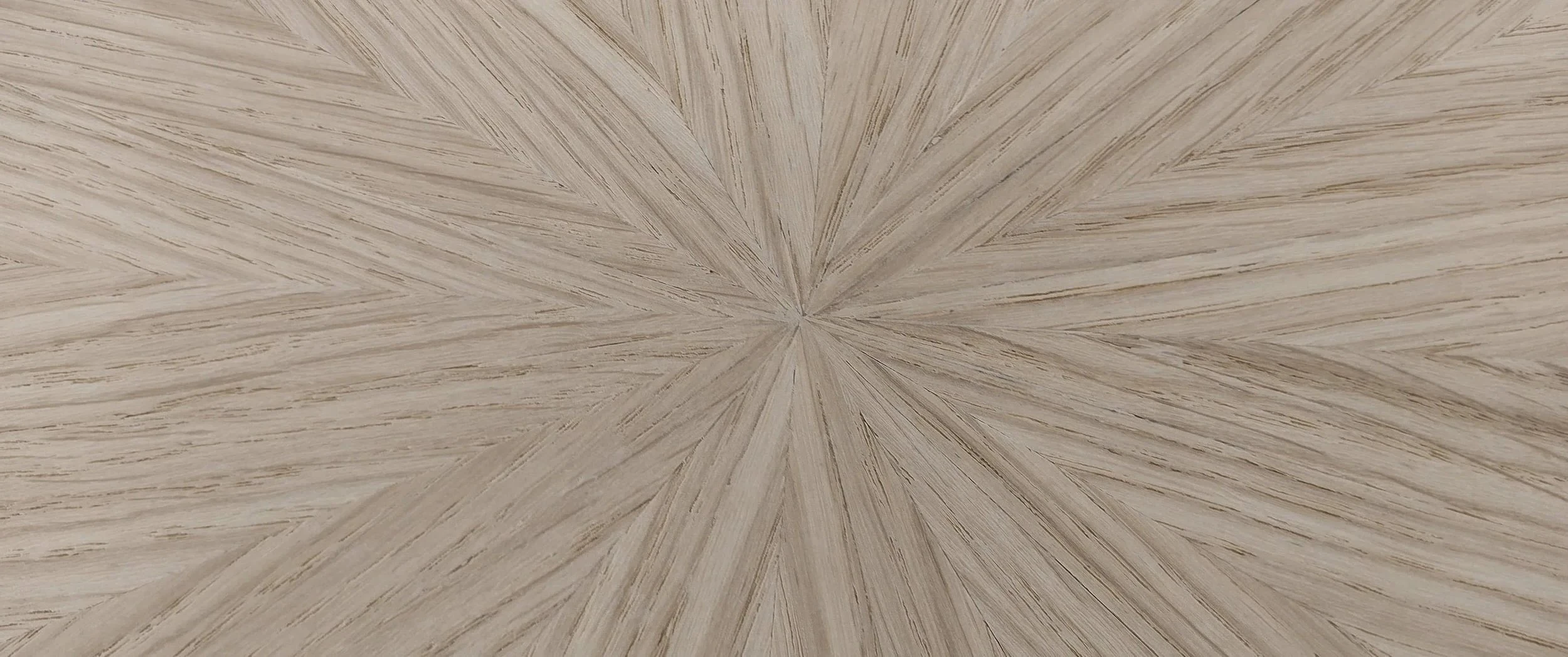 Close view of the finished oak starburst veneer on the Notting Hill dining table top, grain radiating evenly from a single centre point.