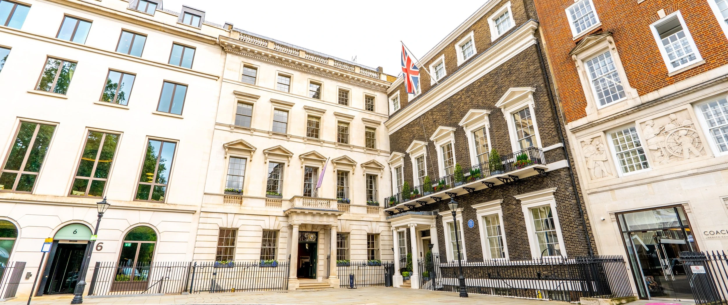 Facade of 5 St James's Square in Central London, a restored Georgian townhouse with classical stonework, tall sash windows and a discreet entrance leading to bespoke private office interiors.